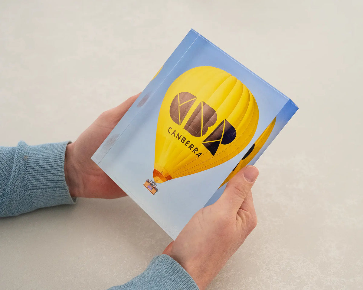 Canberra Bubble. Acrylic block of a Canberra hot air balloon being held in hands.