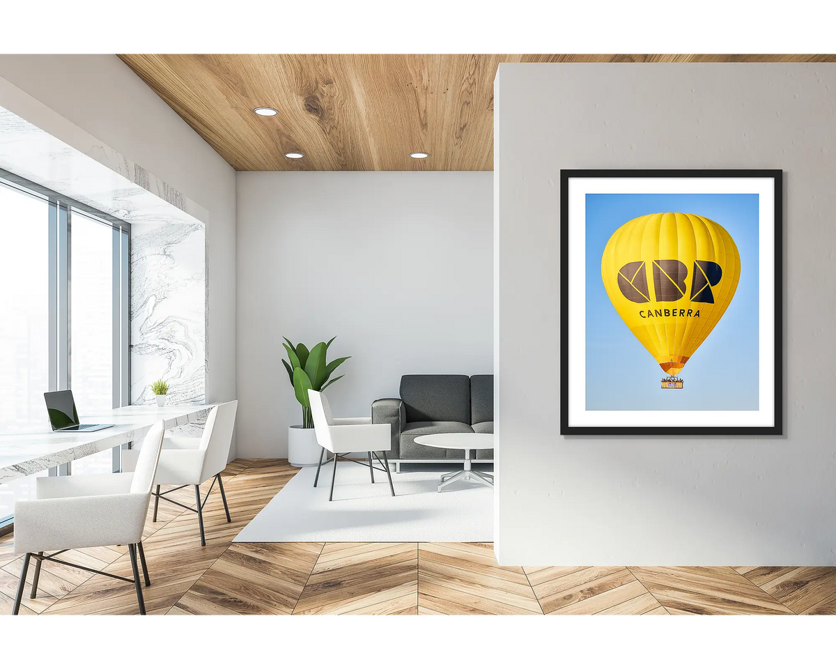 Canberra Bubble. Framed wall art print of CBR Balloon, with a black frame in a bright office lobby. 