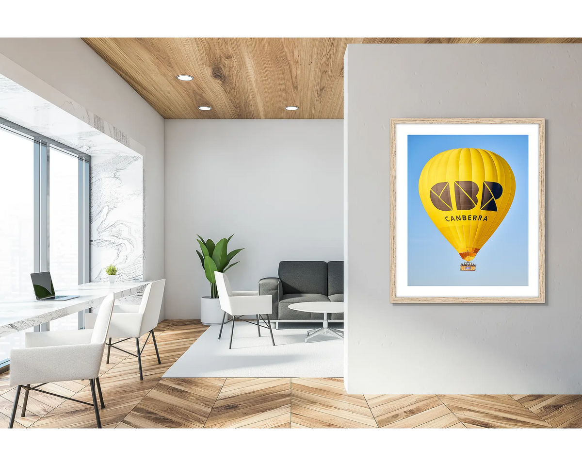 Canberra Bubble. Framed wall art print of CBR Balloon, with a timber frame in a bright office lobby. 