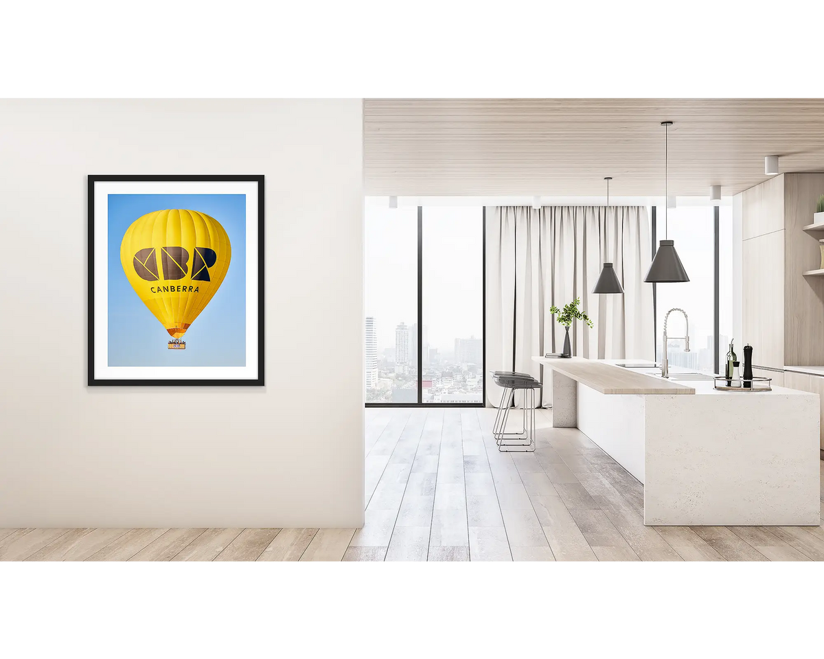 Canberra Bubble. Wall art print of Visit Canberra balloon, with a black frame, hung on a hallway wall. 