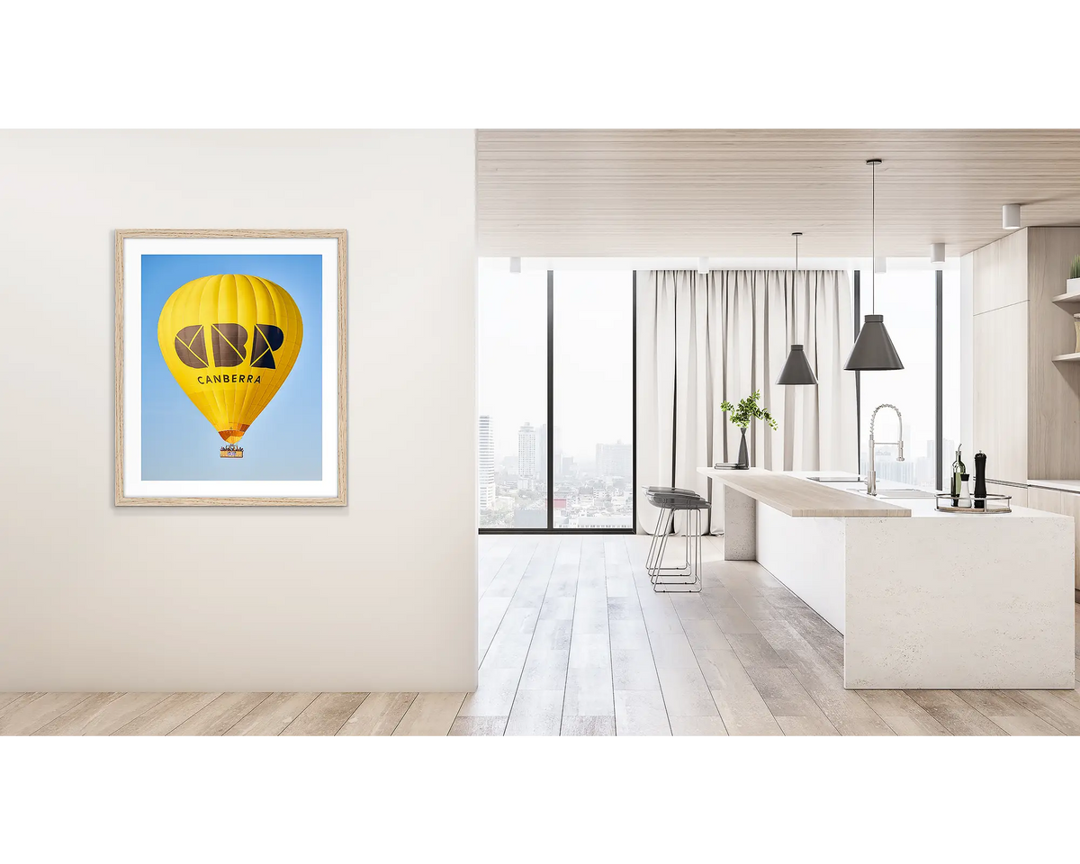 Canberra Bubble. Wall art print of Visit Canberra balloon, with a timber frame, hung on a hallway wall. 