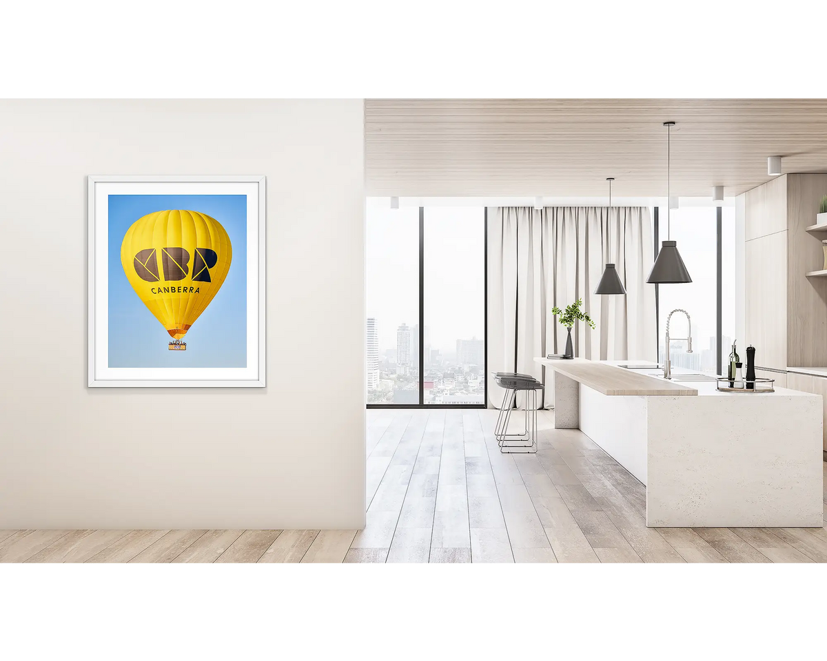 Canberra Bubble. Wall art print of Visit Canberra balloon, with a white frame, hung on a hallway wall. 
