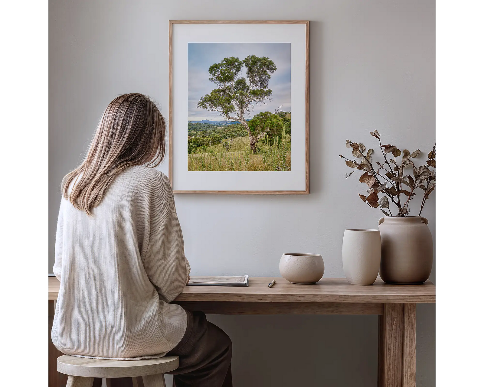Framed artwork of a gum tree in the Canberra bush with Black Mountain in the background. 