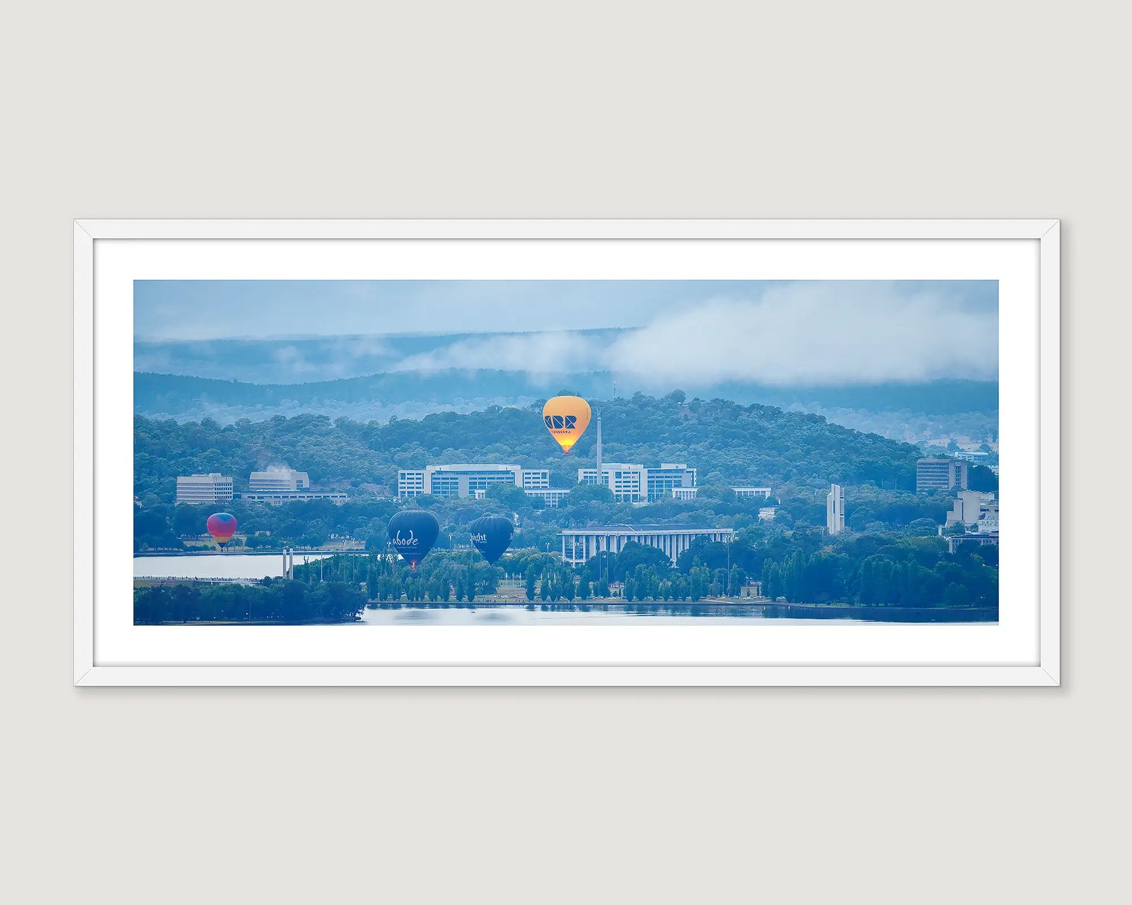 Framed photograph of the CBR balloon floating over the Library on a misty morning. 