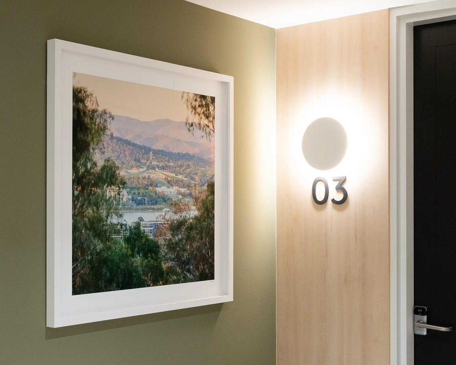 Framed photograph of Parliament House taken from Mount Ainslie with views out to the Brindabella Ranges. 