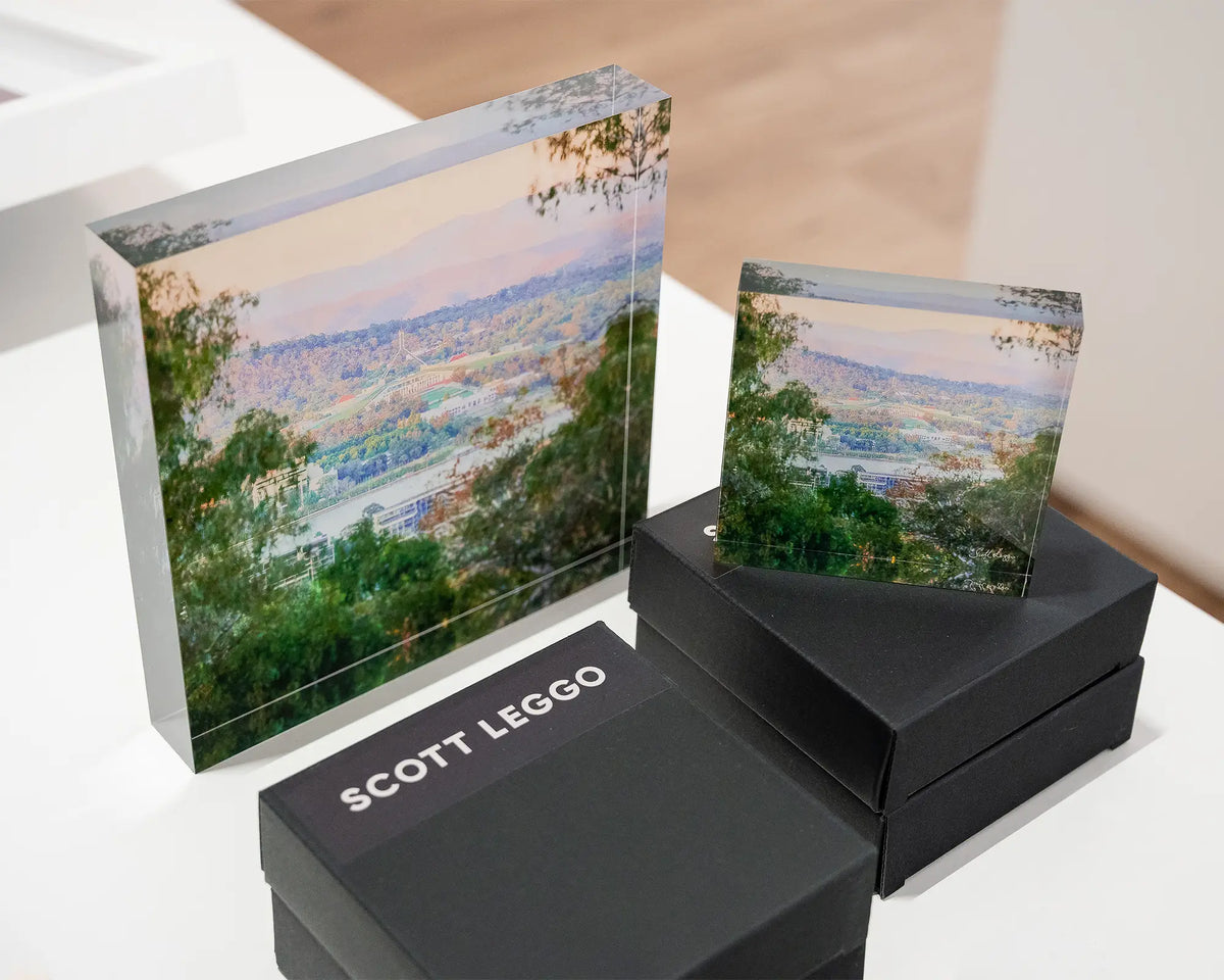 Capital View. Views of Parliament House through gum trees, 10cm acrylic block on gift box displayed with 19cm acrylic block.