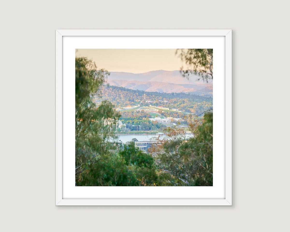Framed photograph of Parliament House taken from Mount Ainslie with views out to the Brindabella Ranges. 