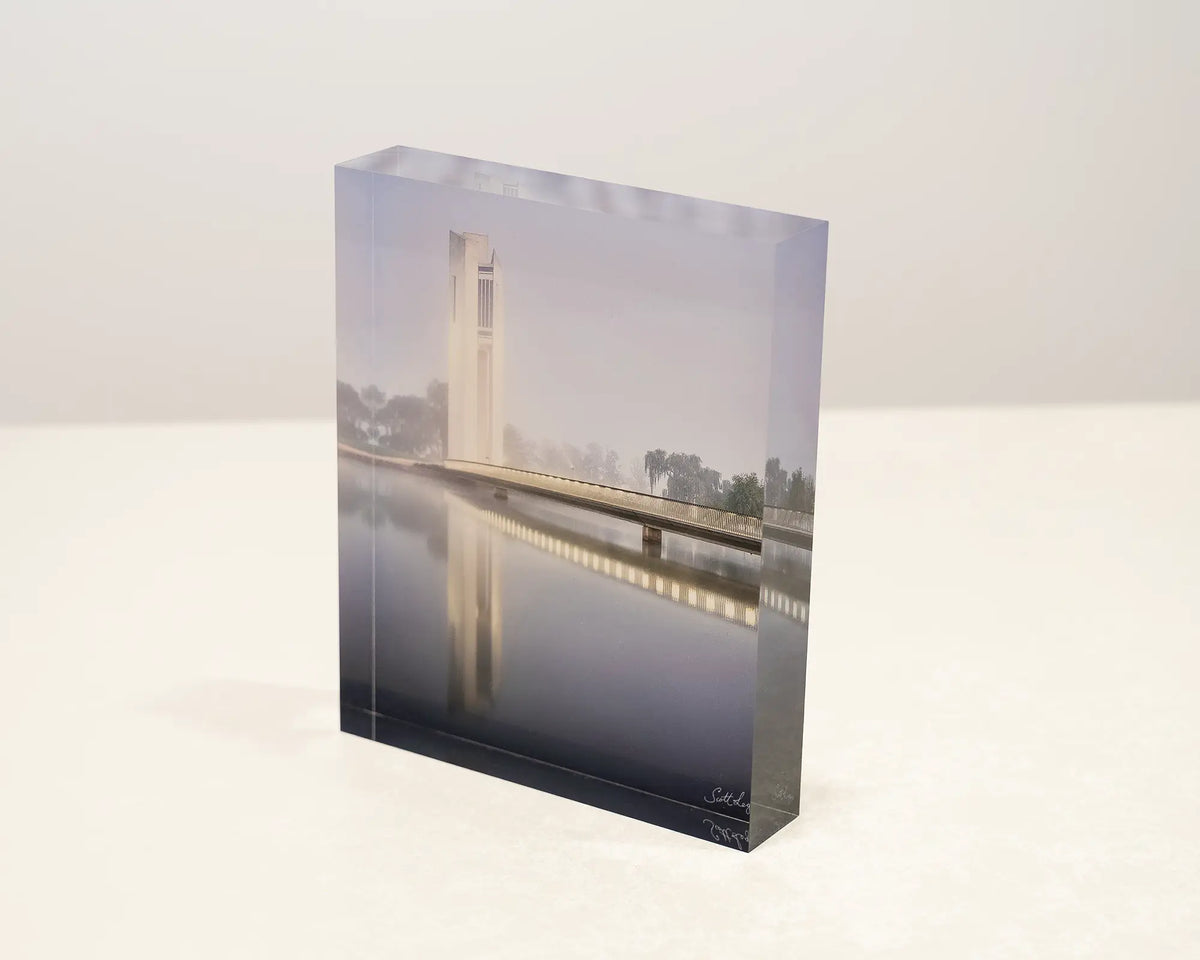 Carillon Blues. Acrylic block of the National Carillon Canberra in. morning fog, sitting on a desk.