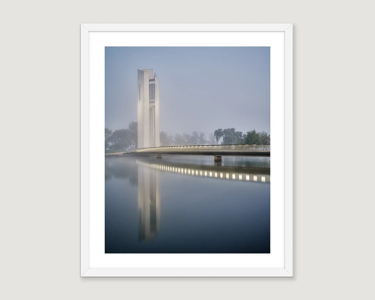 Framed wall art print of the Carillon lit up on a dark foggy morning around Lake Burley Griffin. 
