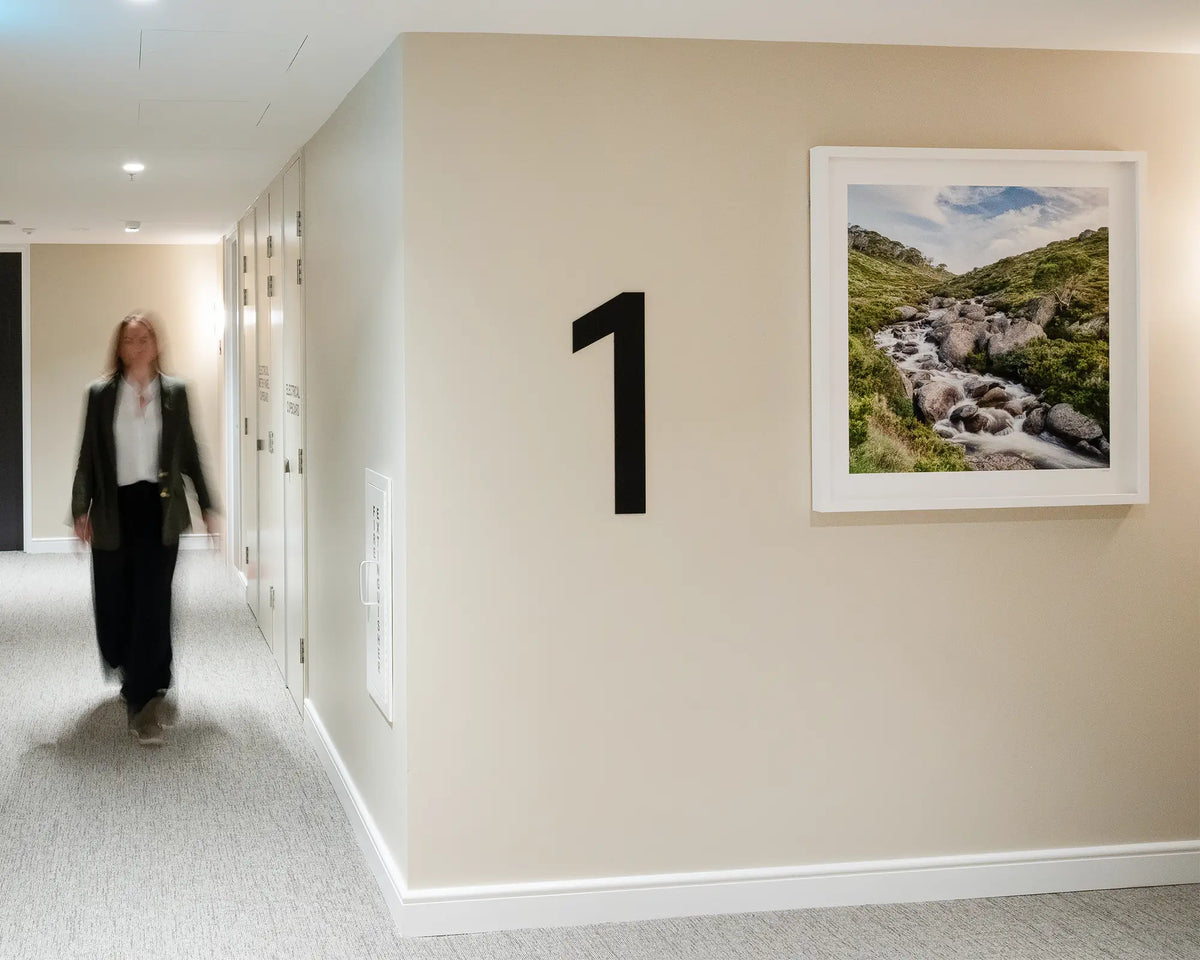 Cascade. Thredbo River, Pilot Wilderness area, Kosciuszko National Park, first floor apartment building with person walking down corridor.