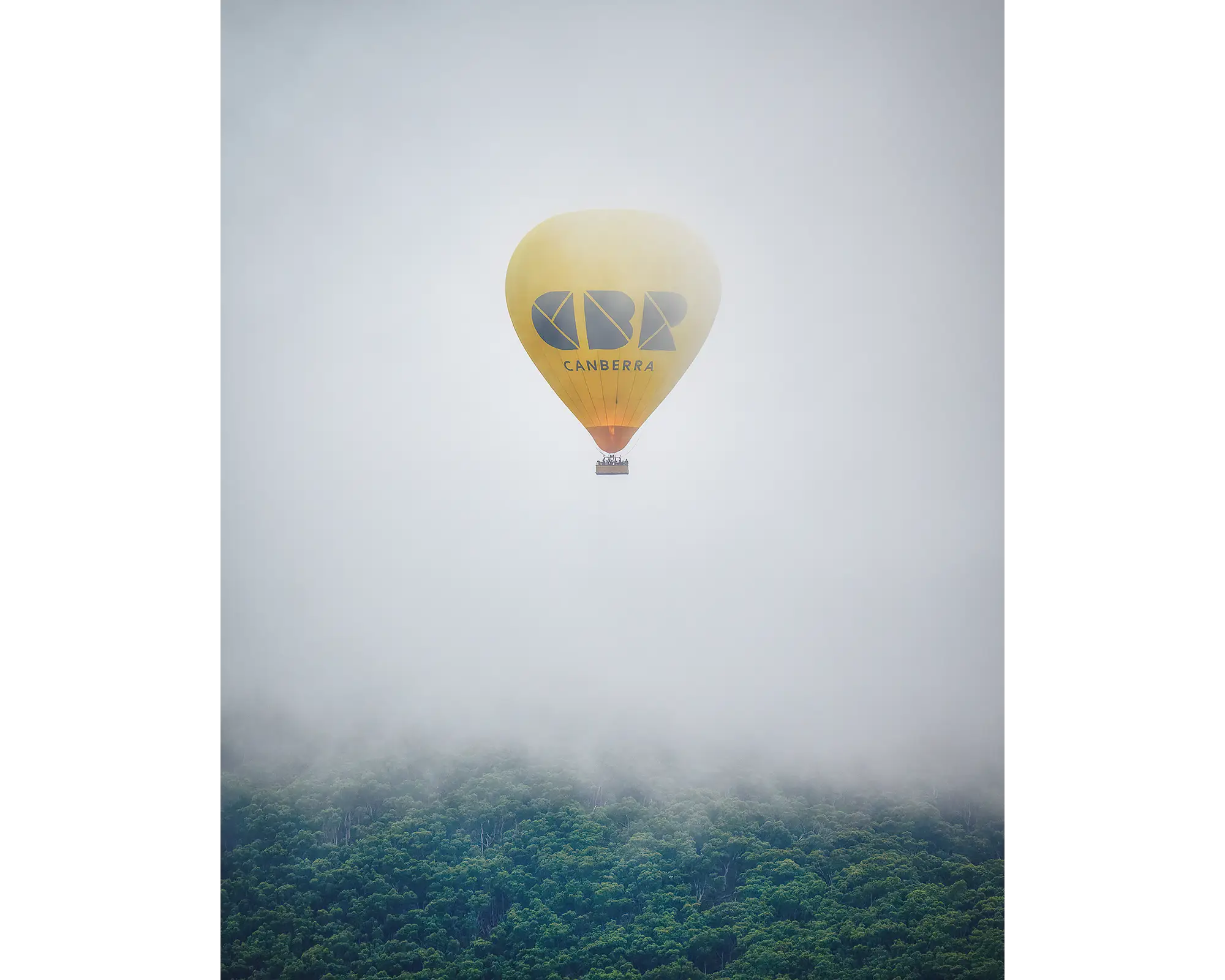 CBR Balloon. Visit Canberra hot ari balloon emergeng from fog over Black Mountain during Canberra balloon festival.