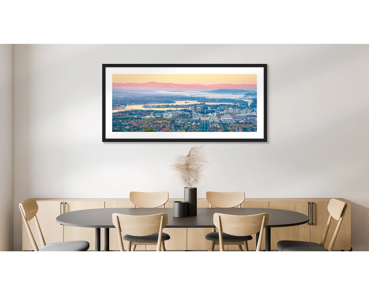 Civic Autumn. Photographic wall art print of an autumn sunrise over Canberra, framed in a black frame and hung on a dining room wall. 