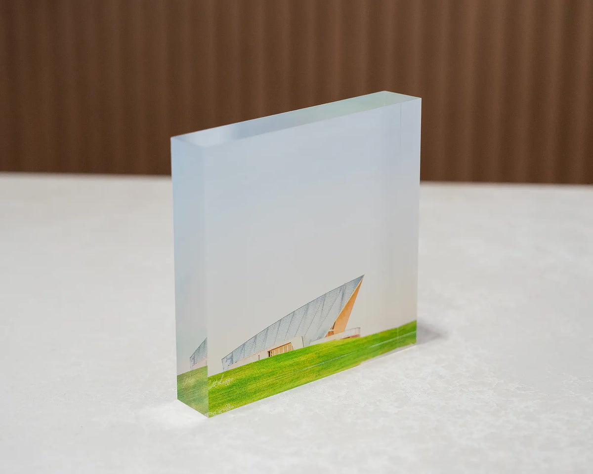 Clarity. Acrylic block Margaret Whitlam Pavilion, National Arboretum, Canberra, sitting on desk.