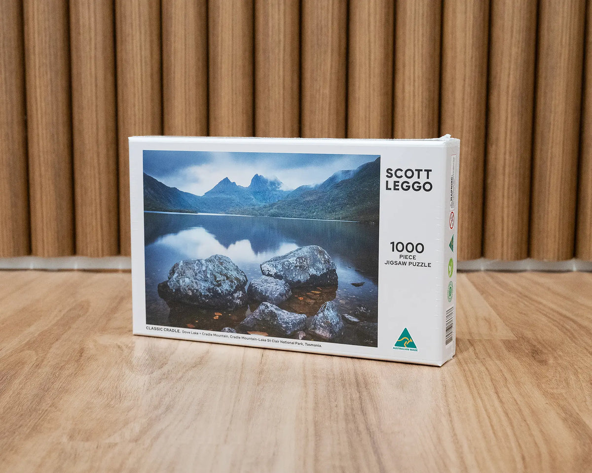 Classic Cradle. 1000 piece jigsaw puzzle of Cradle Mountain, Tasmania, with wood panel background.