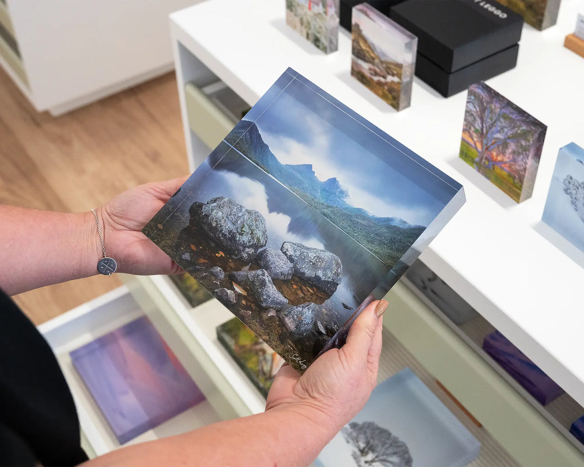 Classic Cradle. Acrylic block of Dove Lake, Cradle Mountain Tasmania, being held in hands.