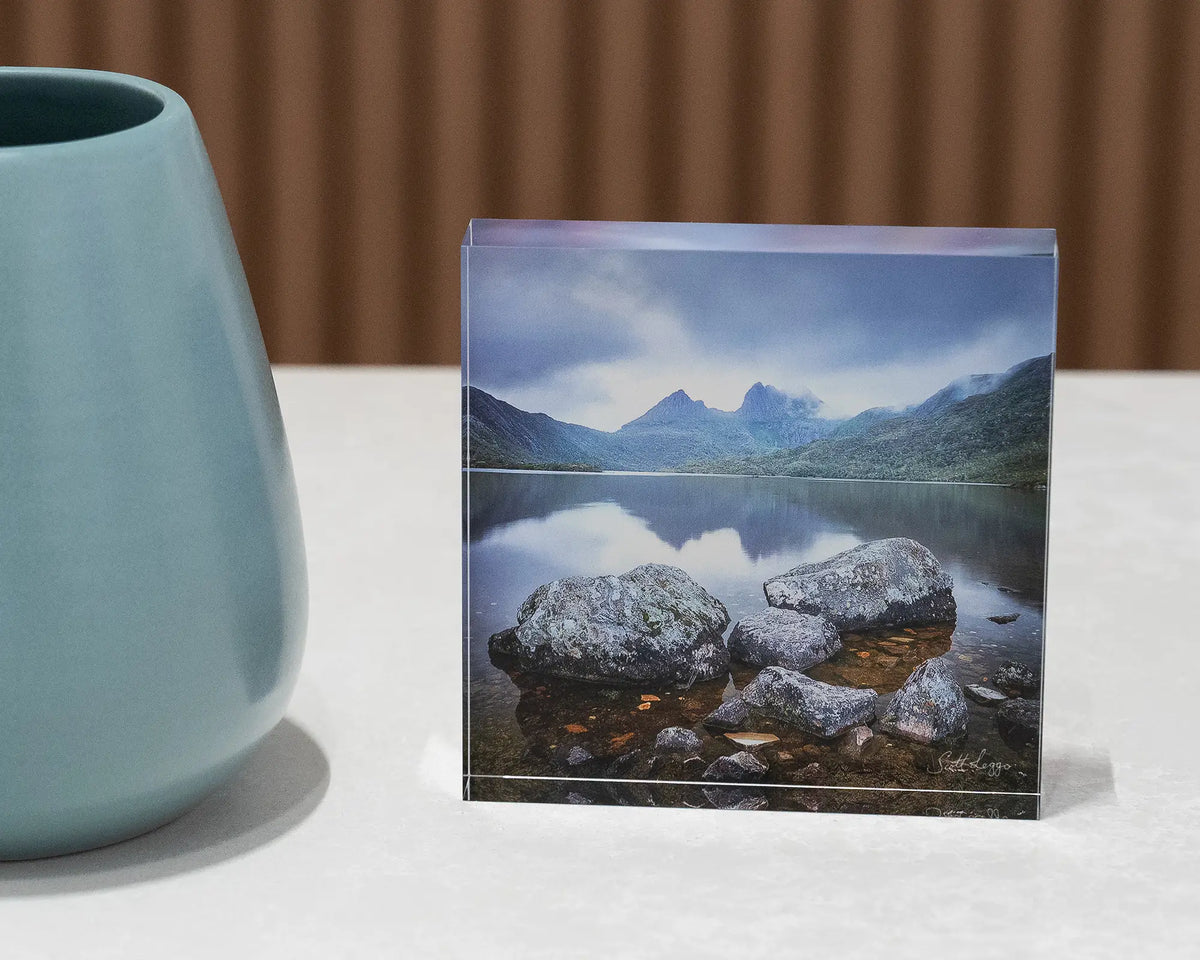 Classic Cradle. Acrylic block Dove Lake, Cradle Mountain, Tasmania, on desk w ith small vase.