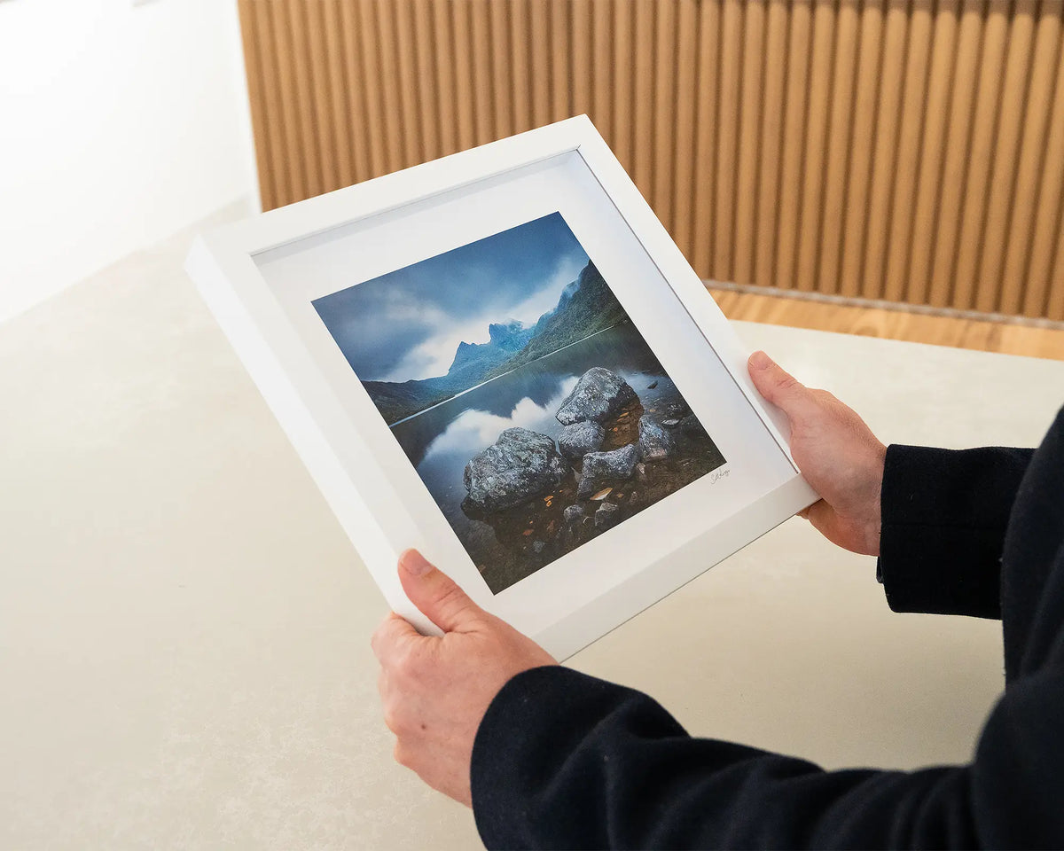 Classic Cradle. Cradle Mountain Tasmania, small framed print with white frame being hand held.