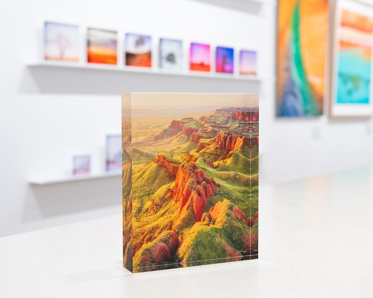 Classic Kimberley. Acrylic block Ragged Range, Western Australia, on gallery desk with more SCOTT LEGGO artworks in background.