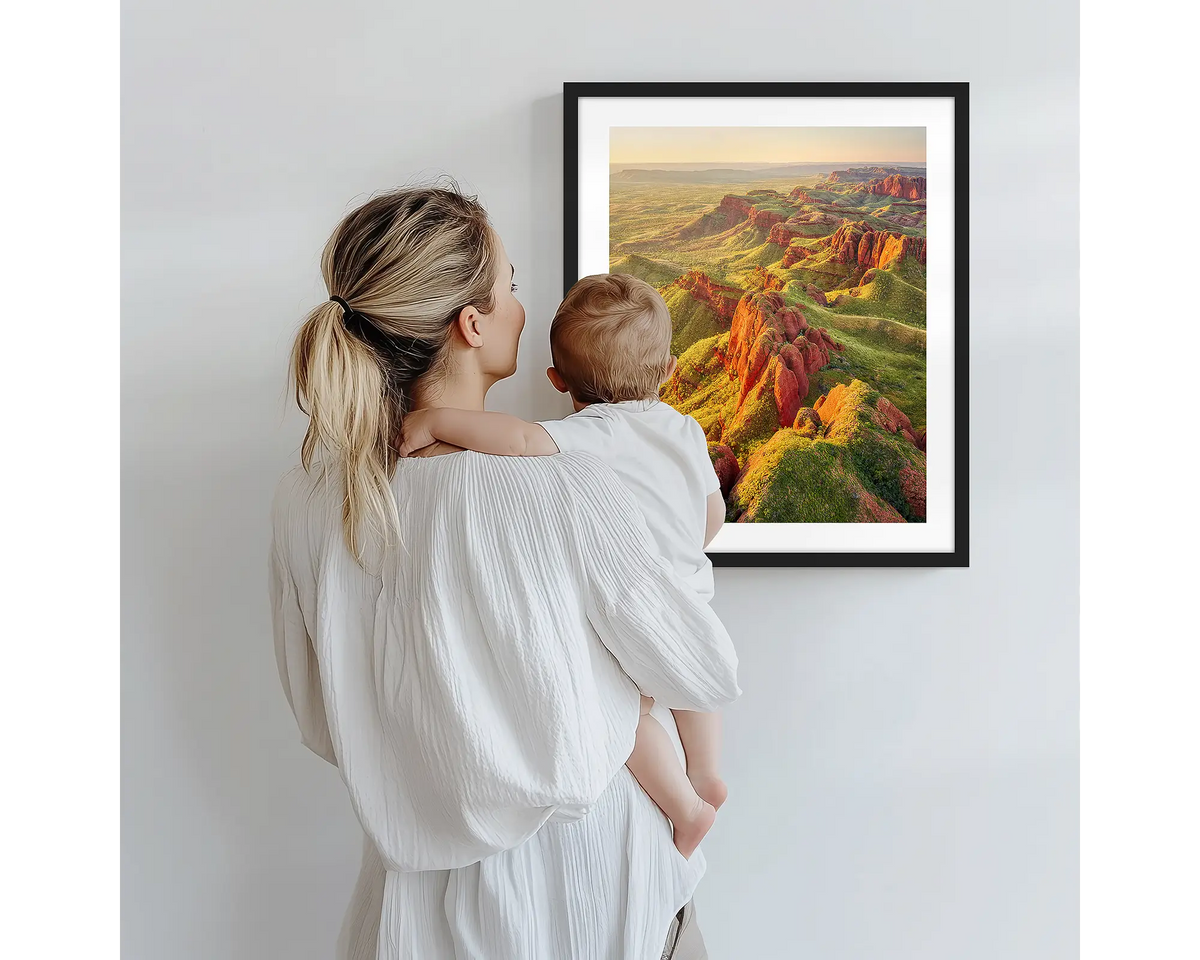 Classic Kimberley. Nature photography artwork, with a black frame, being admired by a mother and baby. 