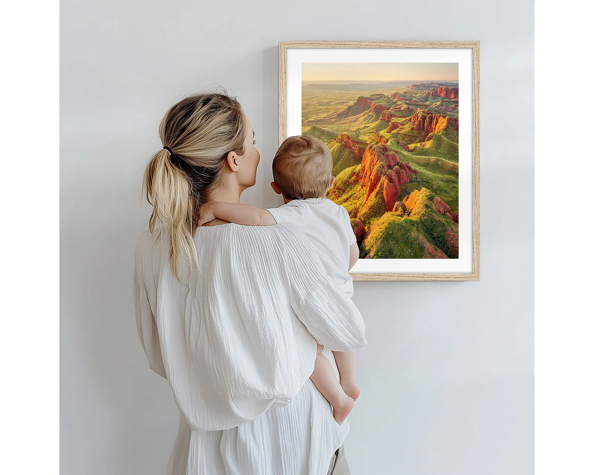 Classic Kimberley. Nature photography artwork, with a timber frame, being admired by a mother and baby. 