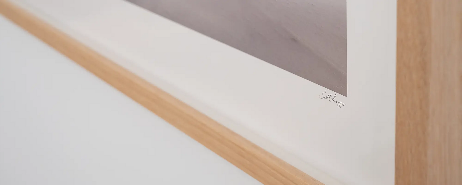 Close up of Scott Leggo wall art print, Alpine Survivor, with Tassie Oak frame.