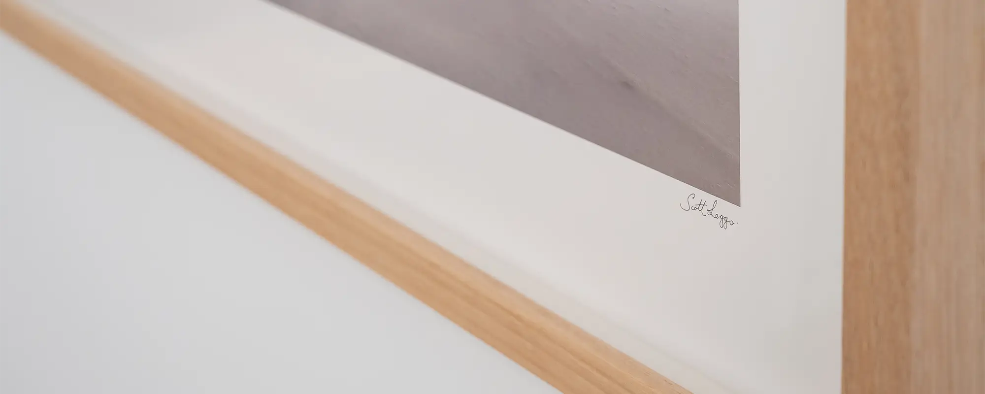 Close up of Scott Leggo wall art print, Alpine Survivor, with Tassie Oak frame.