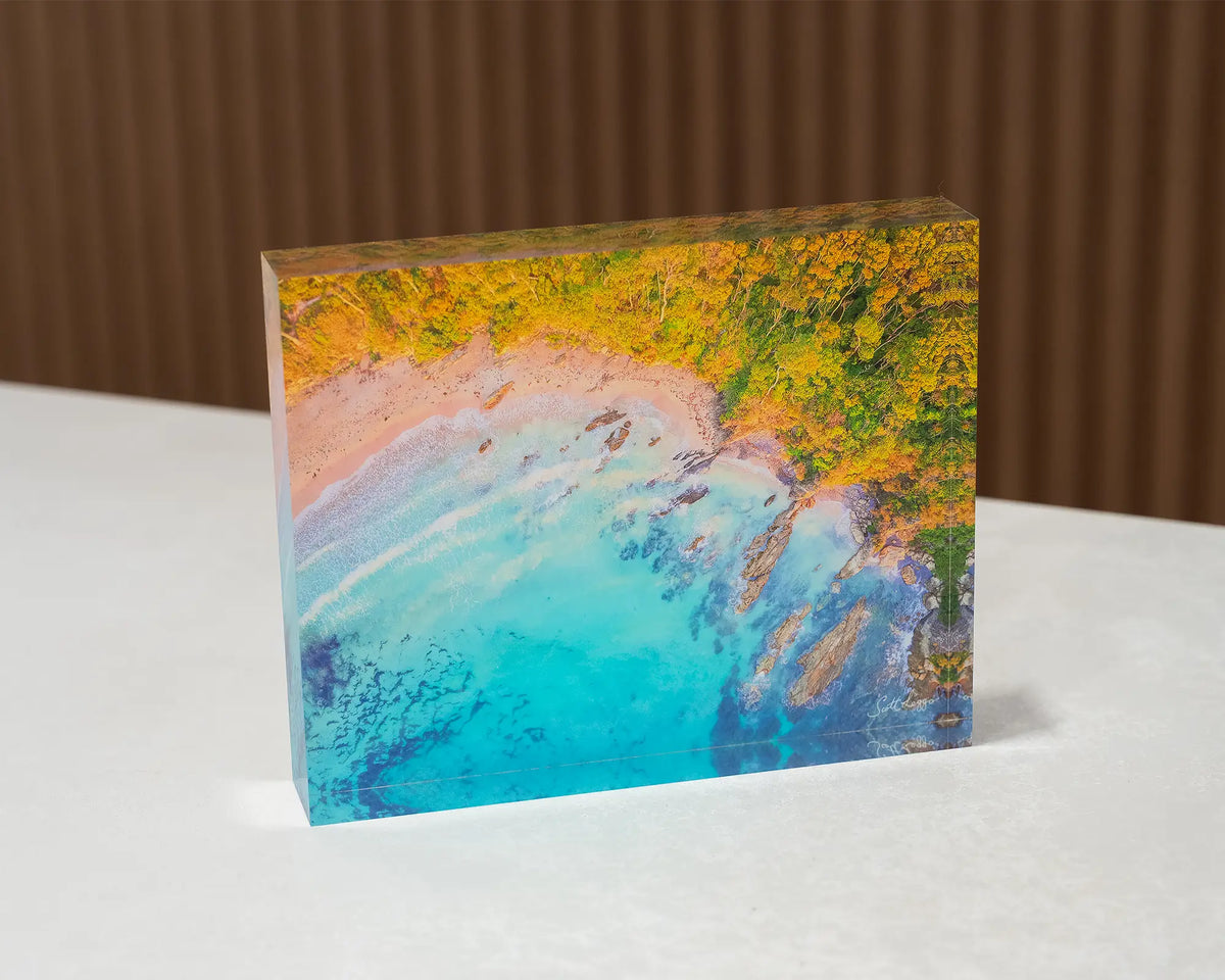 Coastal Bliss. Acrylic block of sunrise at Lilli Pilli Beach, New South Wales, sitting on a desk.