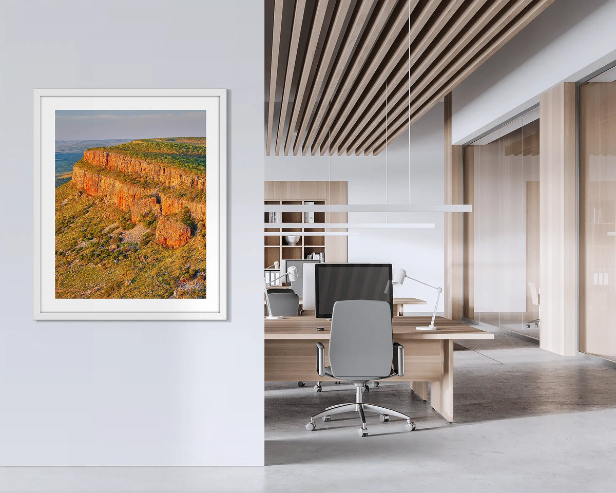 Collapse. Framed Kimberley wall art print, with a white frame, hung on an office wall.  