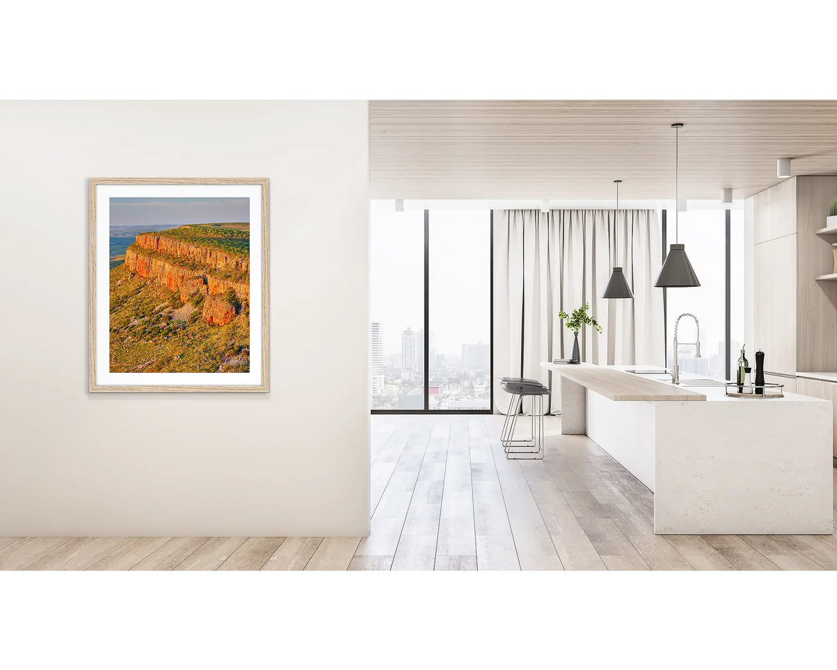 Collapse. Wall art print of Cockburn Ranges at sunset, with a timber frame, hung on a hallway wall. 
