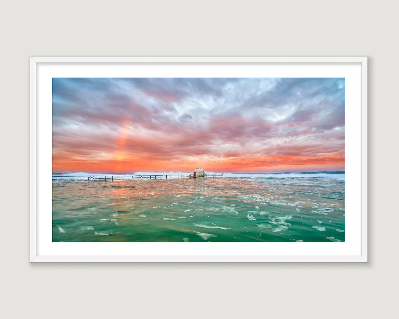 Framed photograph of a stormy sunrise over a choppy green ocean at Merewether Ocean Baths. 
