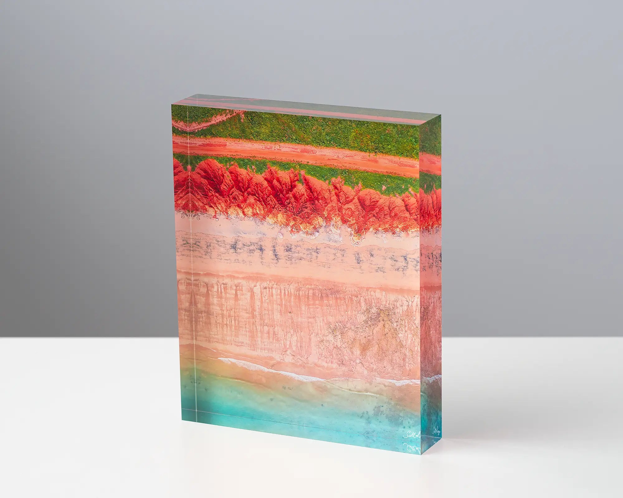 Coloured acrylic block. James Price Point, The Kimberley, aerial artwork sitting on desk.