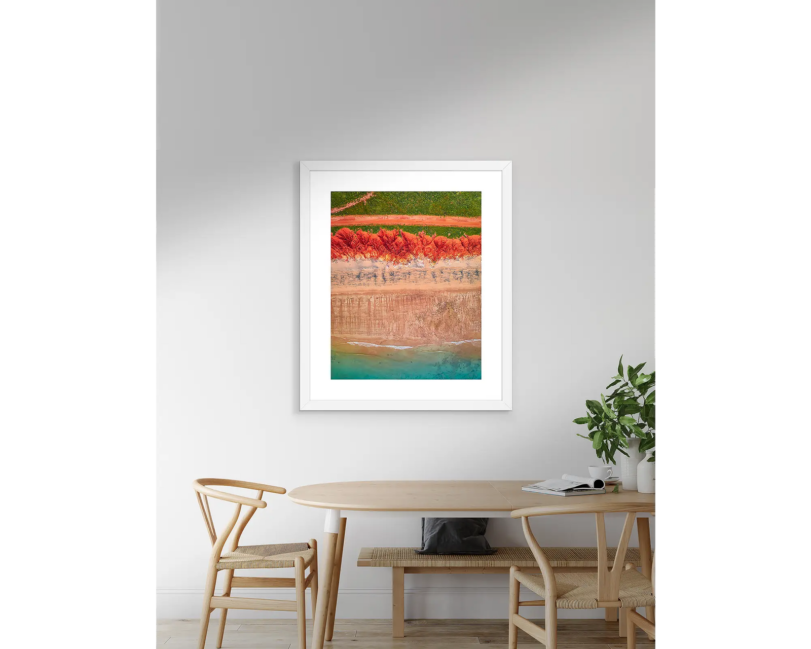 Framed abstract, aerial wall art, of the red earth meeting the turquoise ocean at James Price Point. 