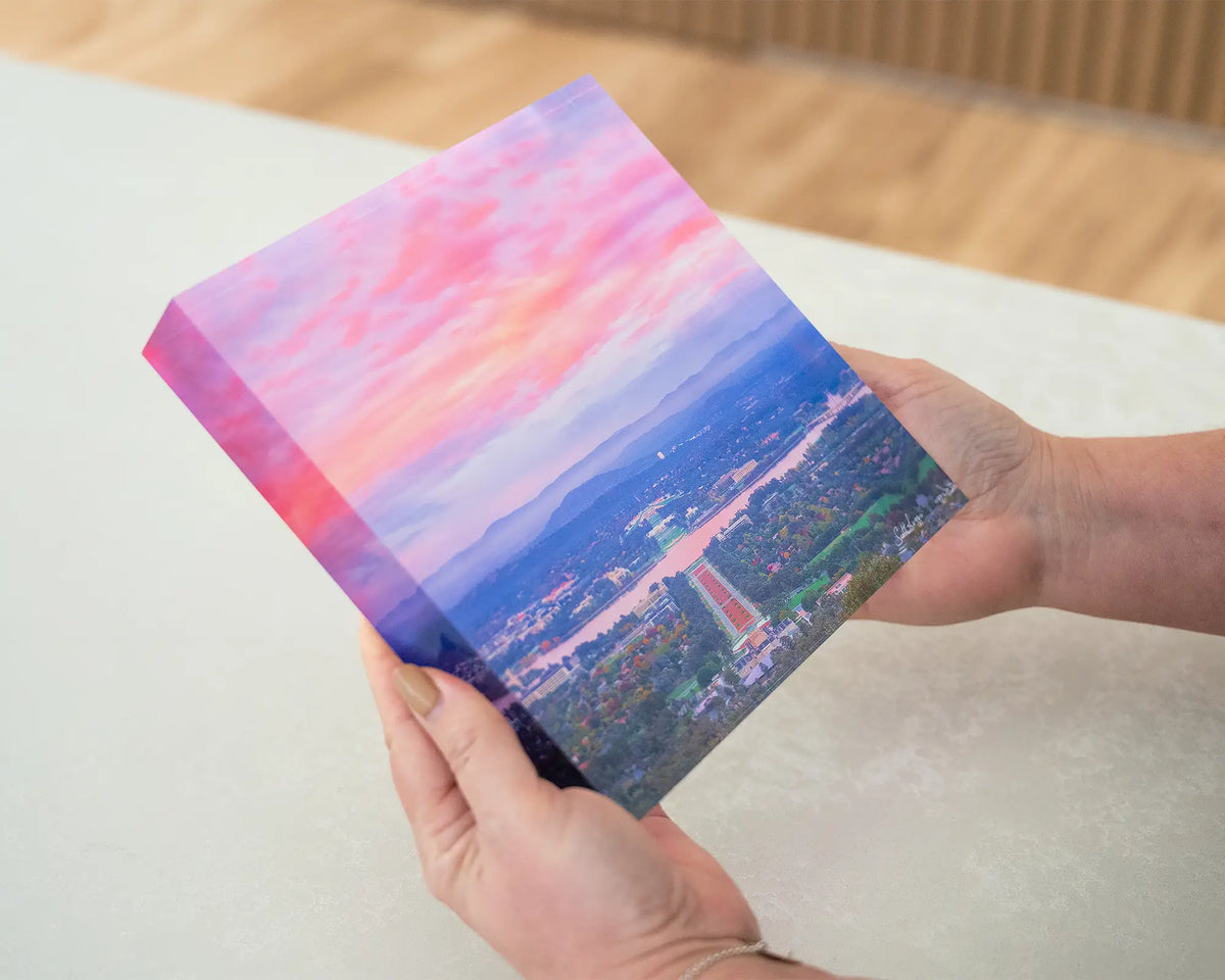 Colours of Canberra. Acrylic block of sunrise over Canberra, being hand held.