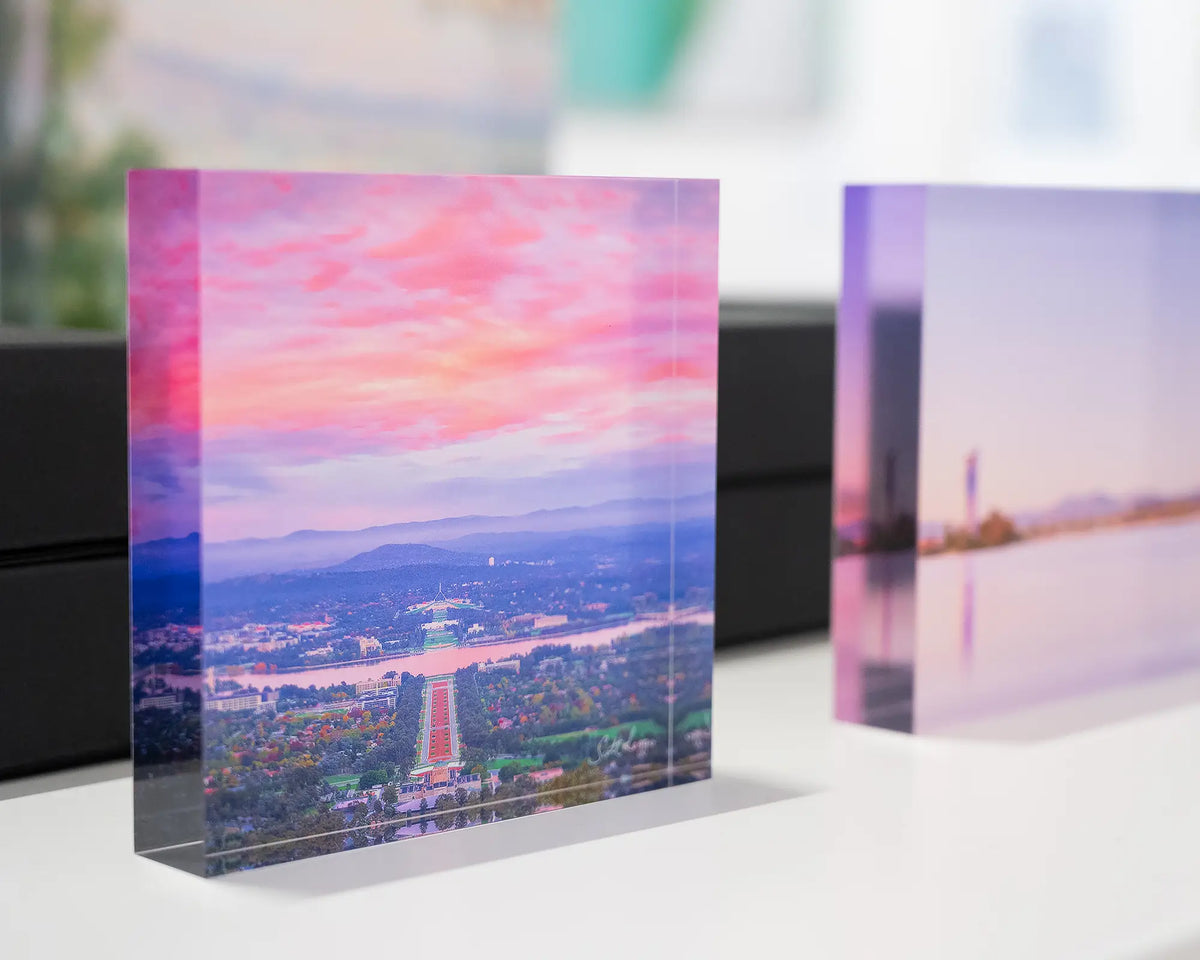 Colours Of Canberra. Acrylic block of sunrise over the capital, on display with more Canberra acrylic blocks.