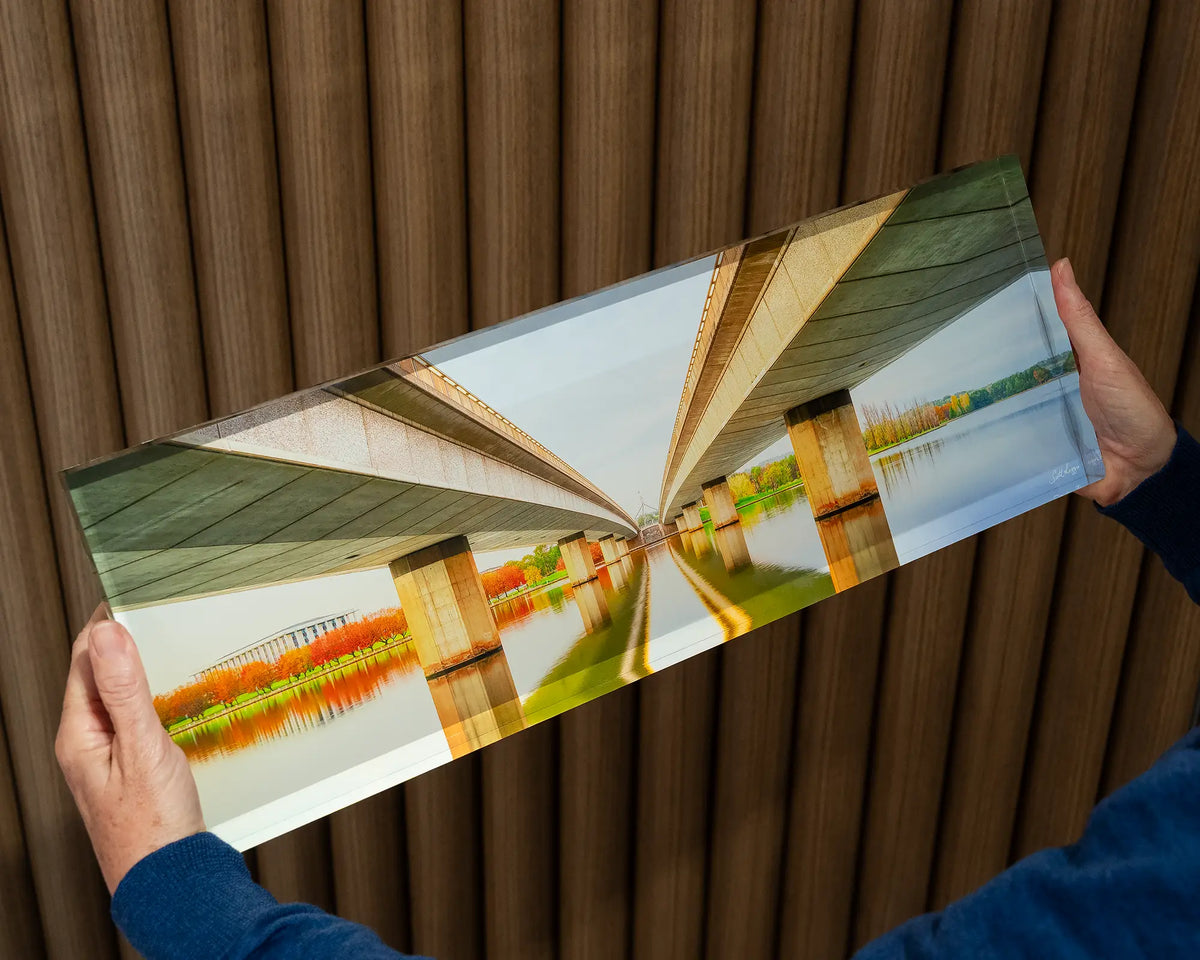 Convergent. Acrylic block of Commonwealth Avenue Bridge Canberra, being hand held.