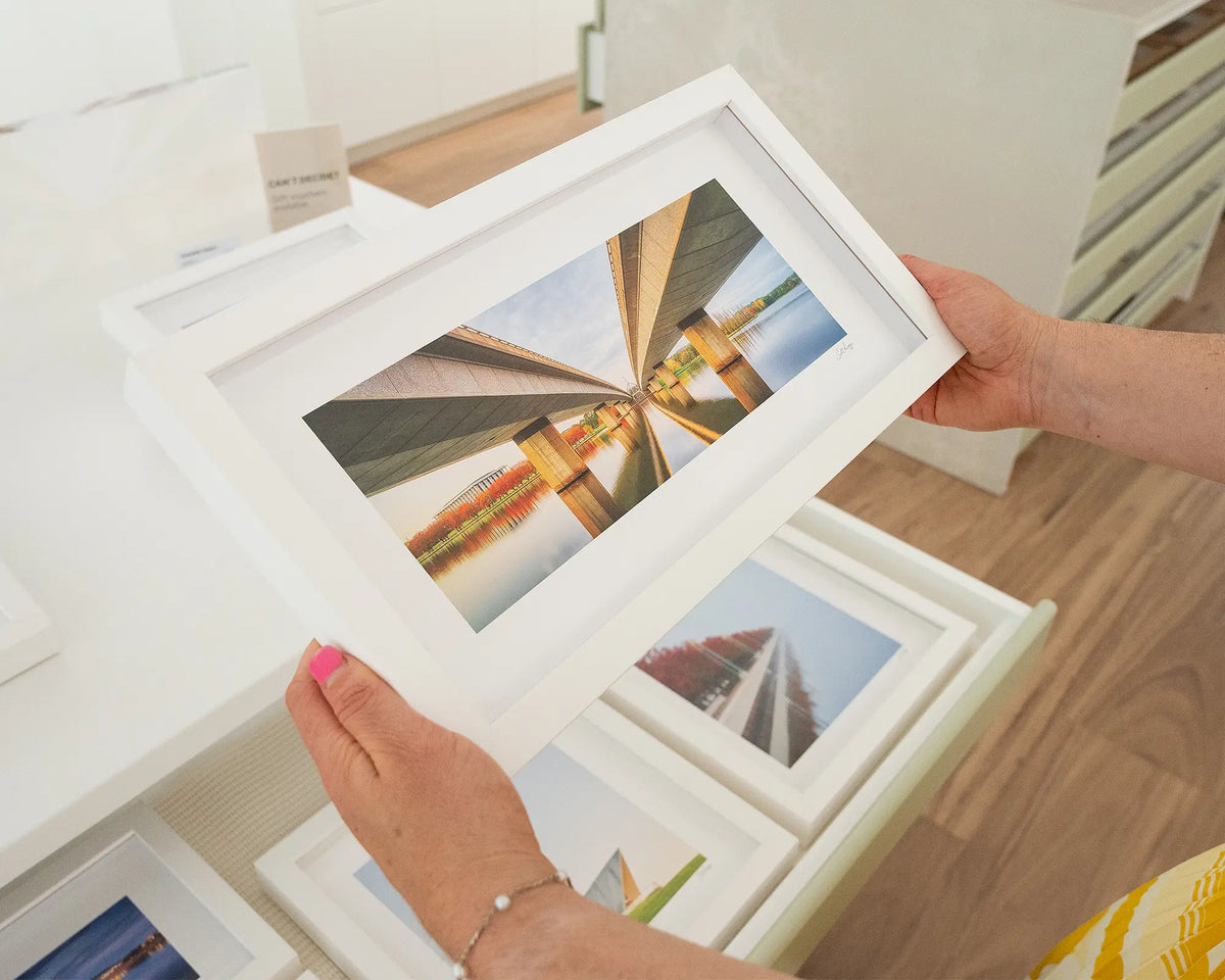 Convergent. Autumn sunrise under Commonwealth Avenue Bridge Canberra with white frame being hand held.