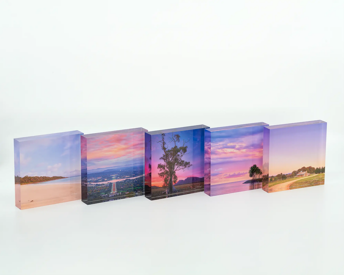 Colours Of Canberra acrylic block of sunrise over Canberra with other square acrylic blocks.