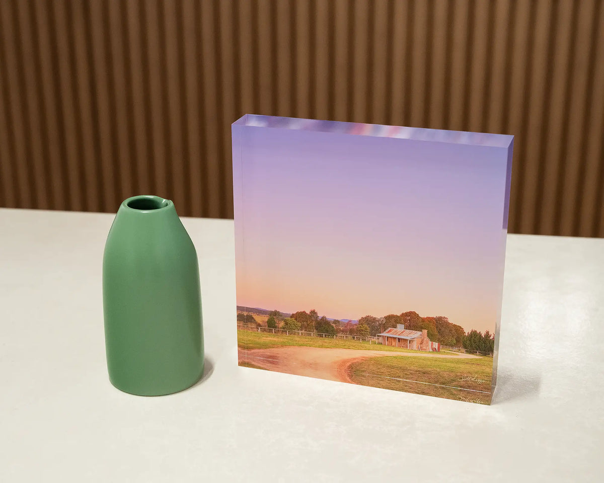 Country Charm. Acrylic block sunset at a Bungendore farmhouse, New South Wales, on desk styled with a small vase.