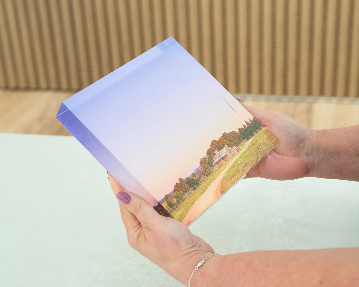 Country Charm. Acrylic block of a sunset at a farmhouse Bungendore, New South Wales, held in hands.