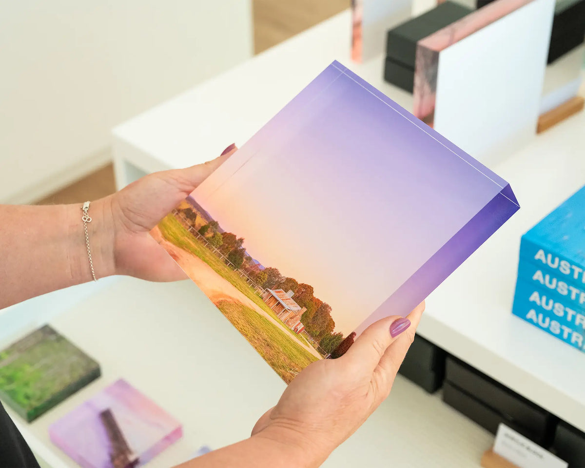 Country Charm. Hand held acrylic block of a sunset on a farmhouse in Bungendore, New South Wales