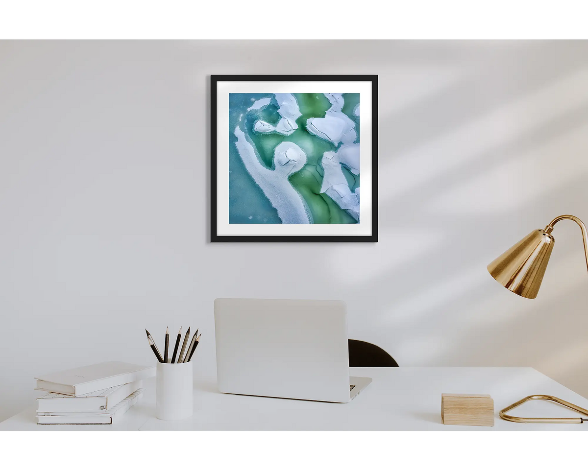 Cracked. Wall art print of snow covered Snowy River, with a black frame in a work from home office.  