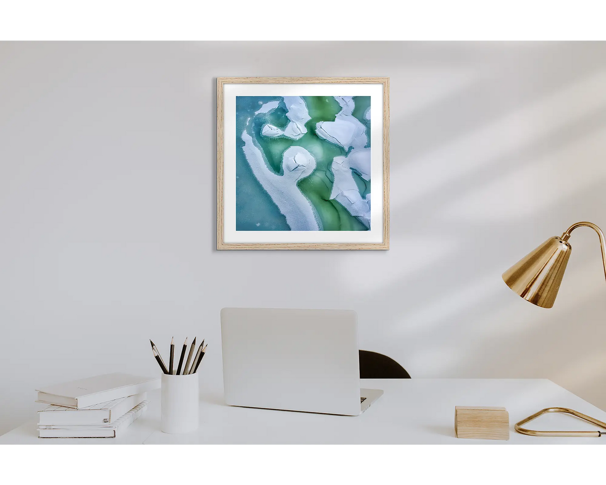 Cracked. Wall art print of snow covered Snowy River, with a timber frame in a work from home office.  