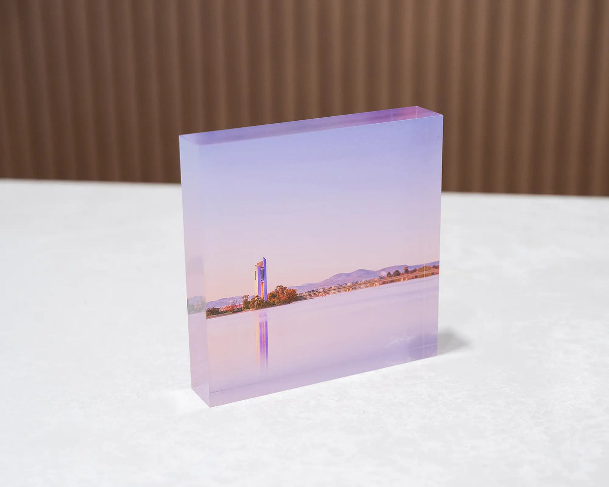 Crisp. Acrylic block of sunrise at the National Carillon, Canberra, sitting on desk.