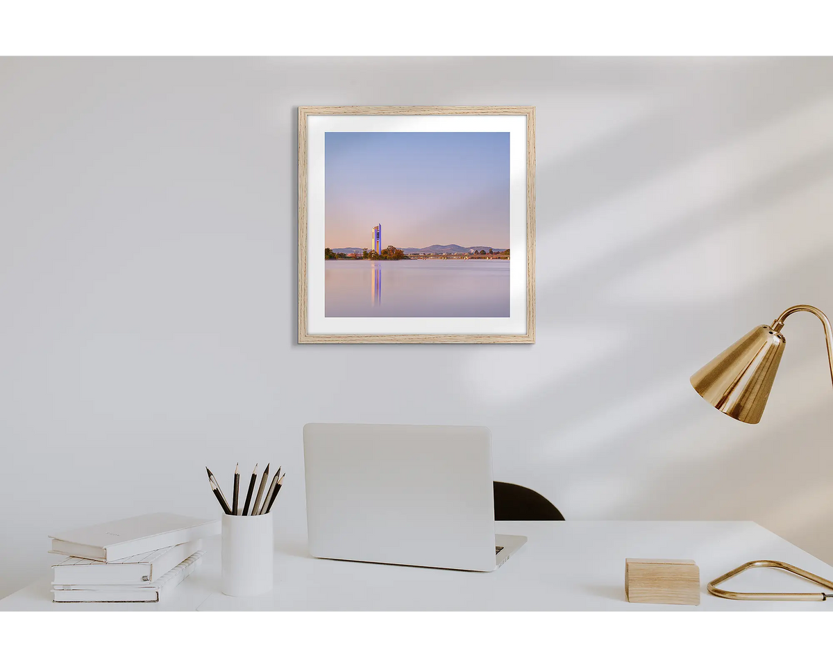 Crisp. Wall art print of a sunrise over the Carillon, with a timber frame in a work from home office.  