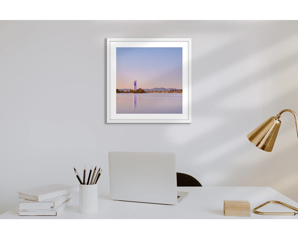 Crisp. Wall art print of a sunrise over the Carillon, with a white frame in a work from home office.  