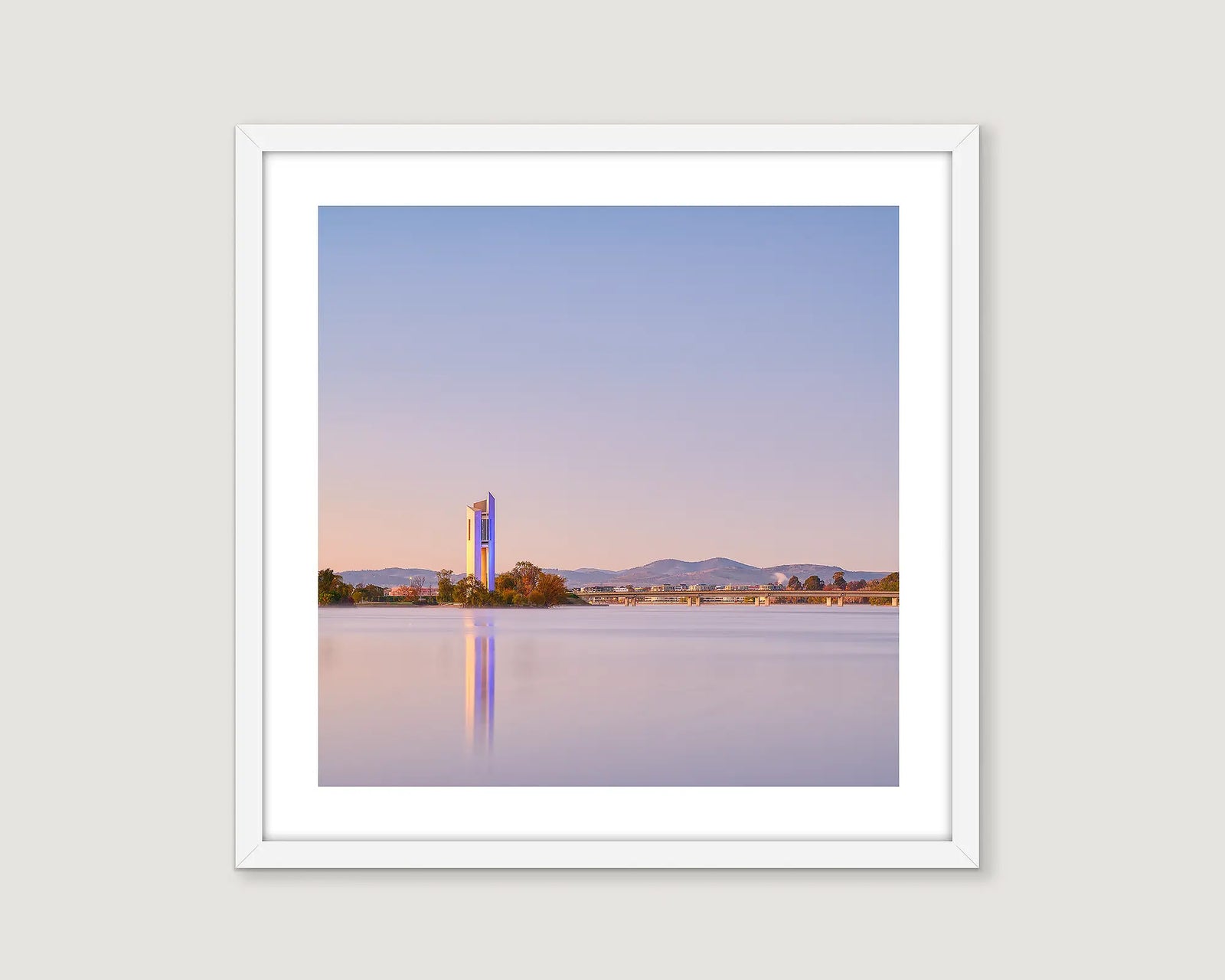 Framed wall art of the National Carillon lit up with neon lights reflecting into Lake Burley Griffin. 