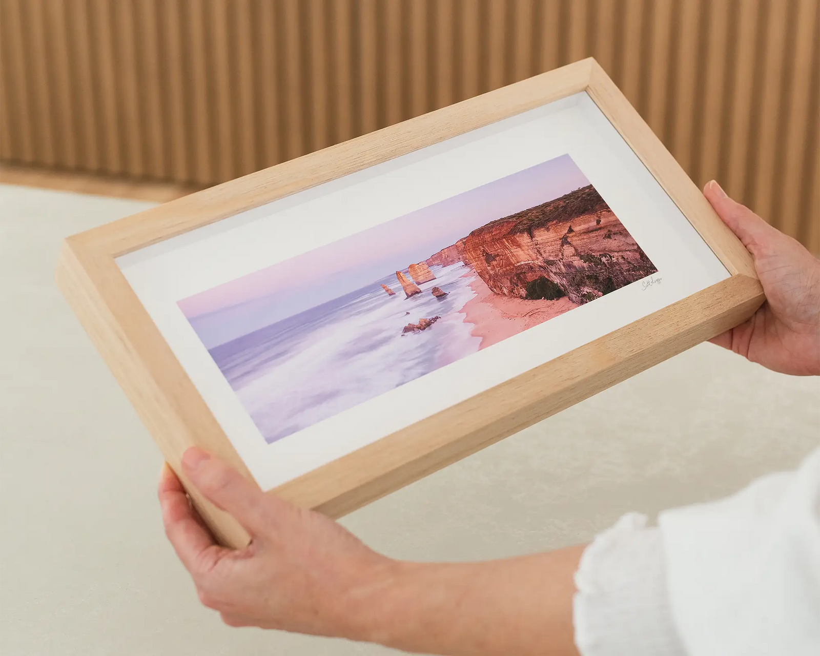 Framed photograph of a cliff and the ocean and the twelve apostles.