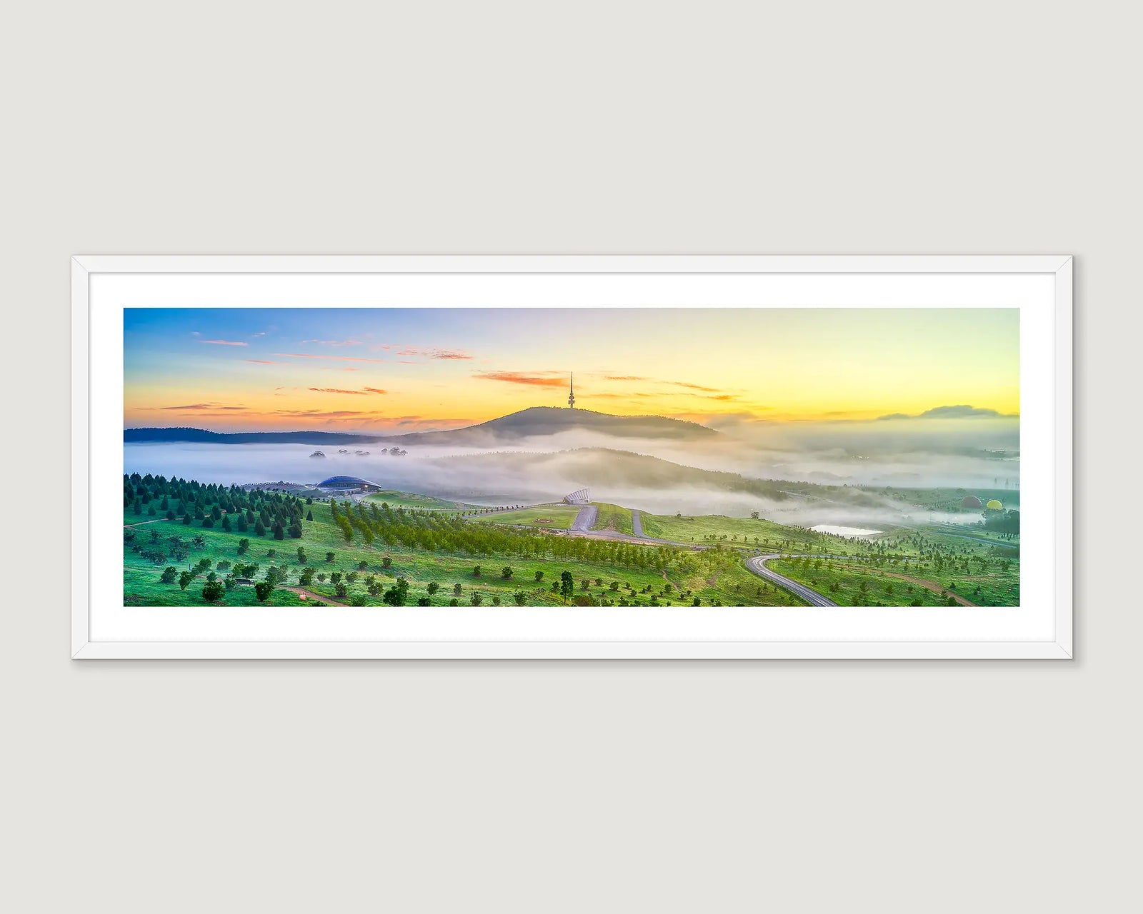 Photographic wall art print of a sunrise over the arboretum and Black Mountain above the mist. 