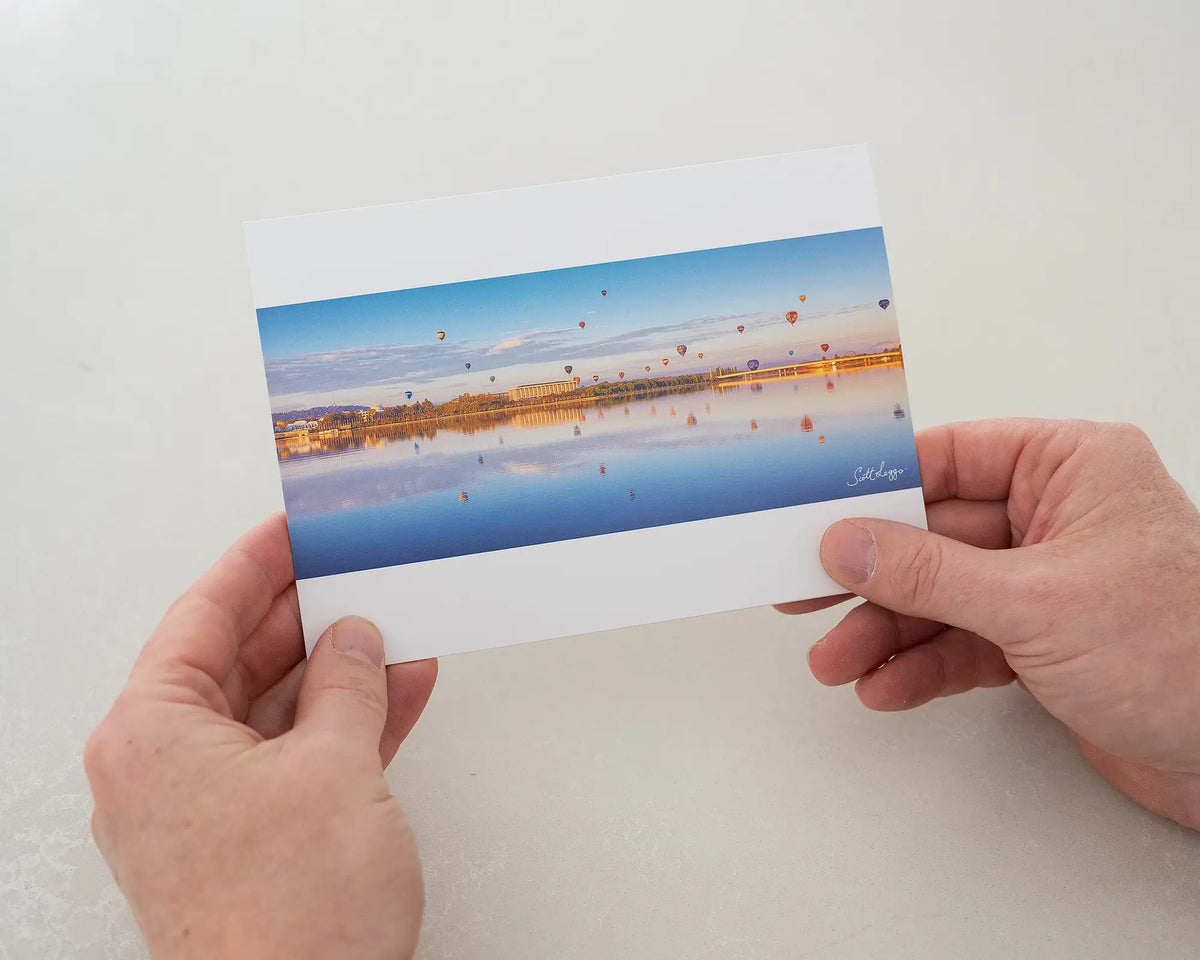Dawn Drifters greeting card being held in two hands.