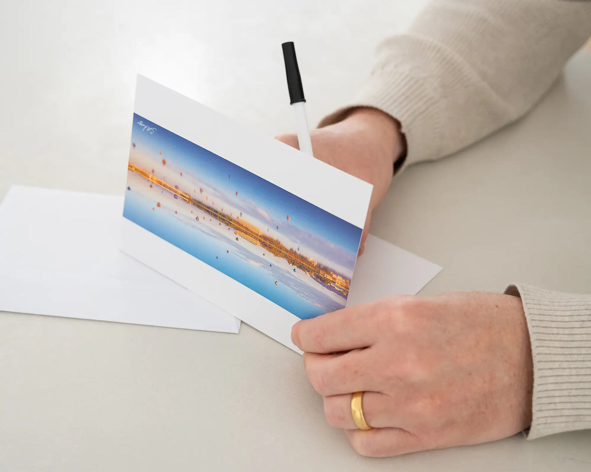 Dawn Drifters greeting card being written in with black pen.